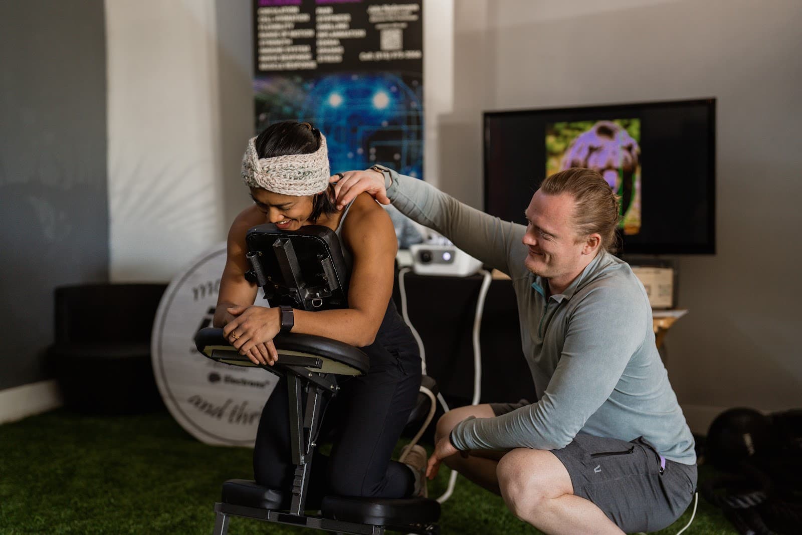 Jake working on a client's shoulder during an in-office Electrons Plus session